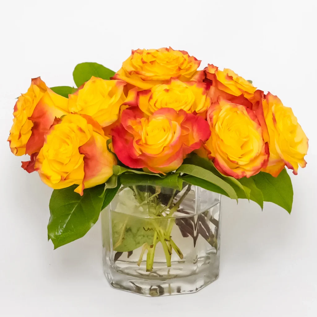 Deluxe Sahara Sunrise rose arrangement featuring extra yellow and orange roses in a clear glass vase, available for flower delivery in Los Angeles and same-day flower delivery service.